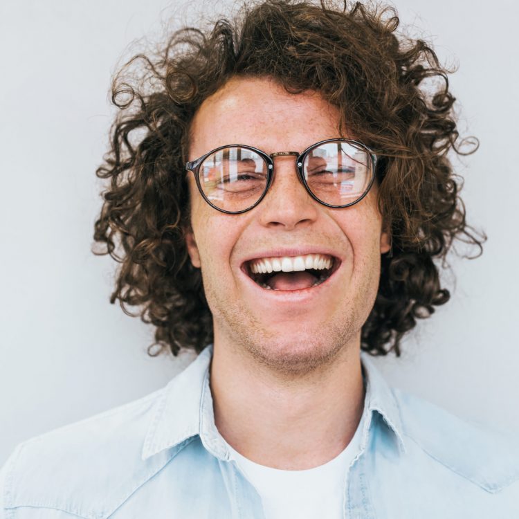 Closeup studio shot of handsome freckled positive smiling male posing for social advertisement, isolated on white background with copy space for your promotional information or content. People race Periodontal Therapy Clyde, OH